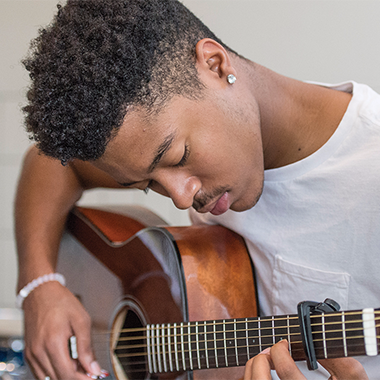 Student playing guitar
