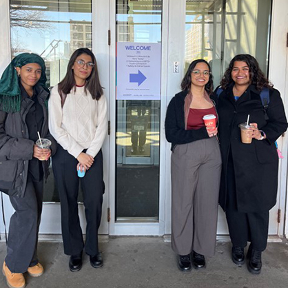 Ja’nya Hill, Moushume Chowdhury, Gauri Birmole, and Ria Maindan moments before presenting their research findings.