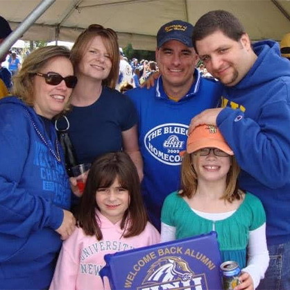 Mia Ribellino ’25, ’26 M.S. (front left) with Charger family at University of New Haven homecoming